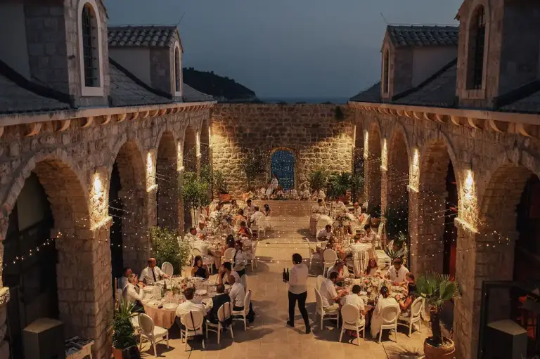 Wedding reception at Lazareti in Dubrovnik, Croatia, showcasing historic stone arches, a spacious cultural venue by the Old Town walls, and a stylish setting for a destination celebration.