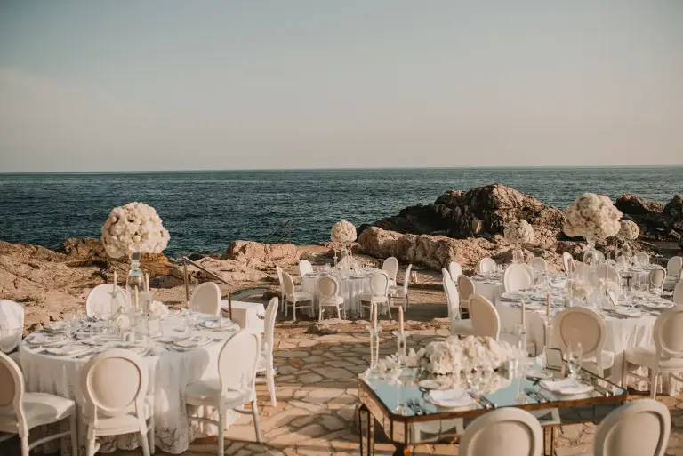 Beachfront wedding ceremony at Vala Beach at Hotel Palace Dubrovnik, featuring a serene rocky shoreline, clear Adriatic waters, and a relaxed coastal setting for a destination wedding.